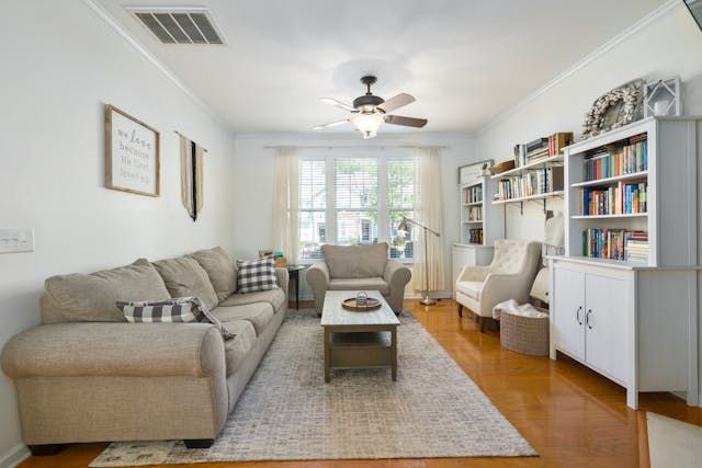 a living room with white walls, an area rug and a grey couch