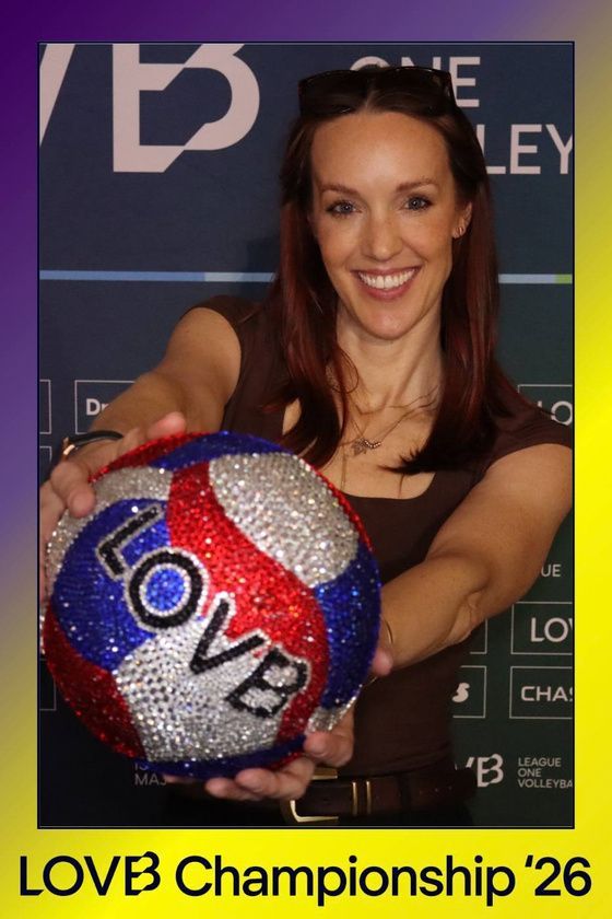 Fan holding a crystal LOVB volleyball in a branded LOVB Championship '26 photo in Long Beach