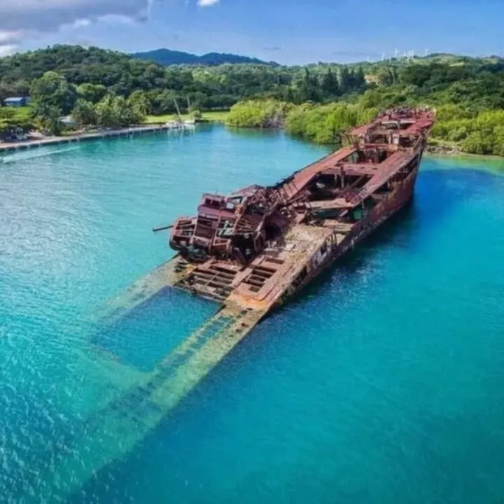 An aerial view of a shipwreck in the middle of a body of water.