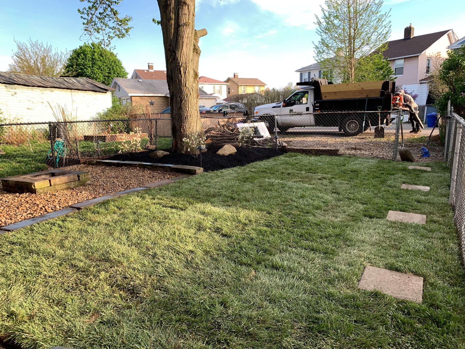 yard afterwards with grass, pavers, mulch, and garden  beds