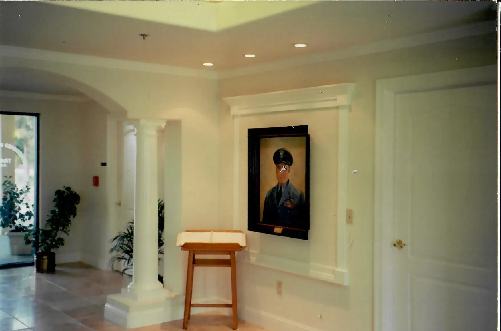 a picture of a man in a military uniform hangs on a wall