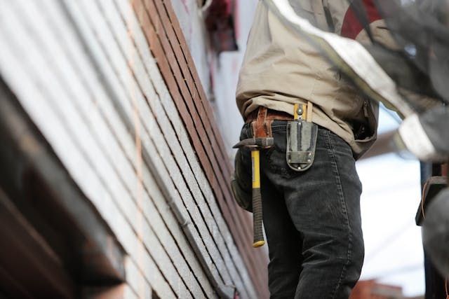 Person wearing a tool belt conducting a home inspection