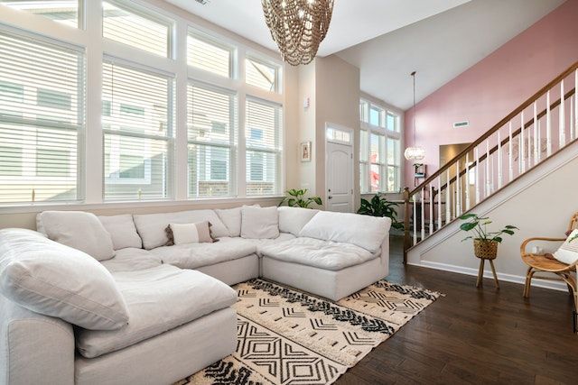Rental property living room with large white couch in front of big picture window