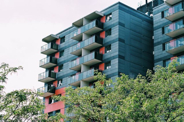 a couple apartment buildings behind trees