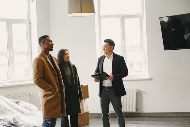 a landlord speaking with two prospective tenants