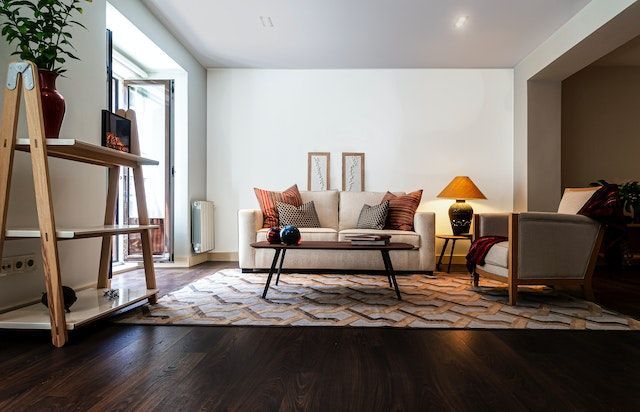 living room with white linen couch and dark wood coffee table