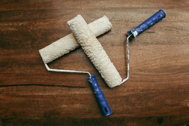 paint rollers on a wood floors