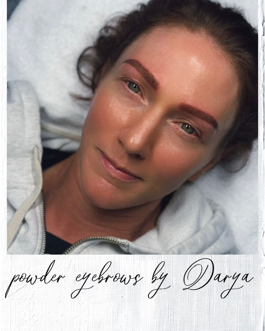 Woman with newly done powder eyebrows, lying down with reddish skin tone and sheen.