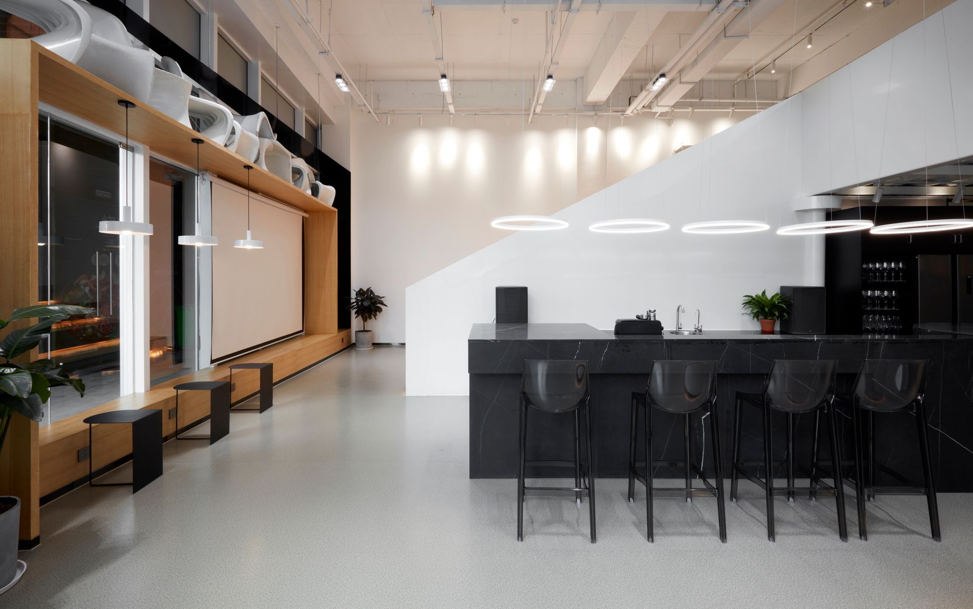 A large room with a bar and stools in it