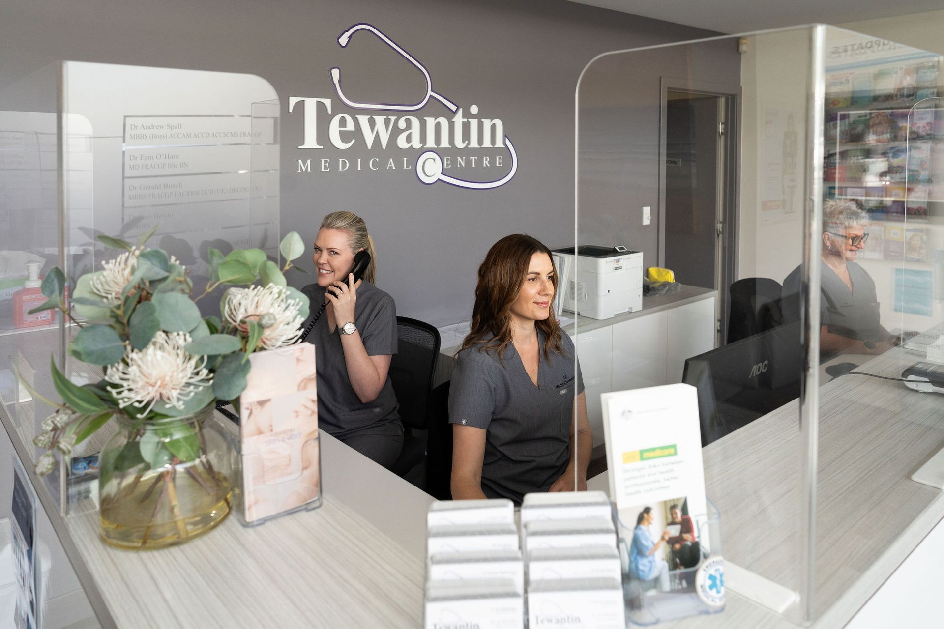 Doctor in White Coat With Stethoscope Holding Clipboard, Writing With Pen — Tewantin Medical Centre In Tewantin, QLD
