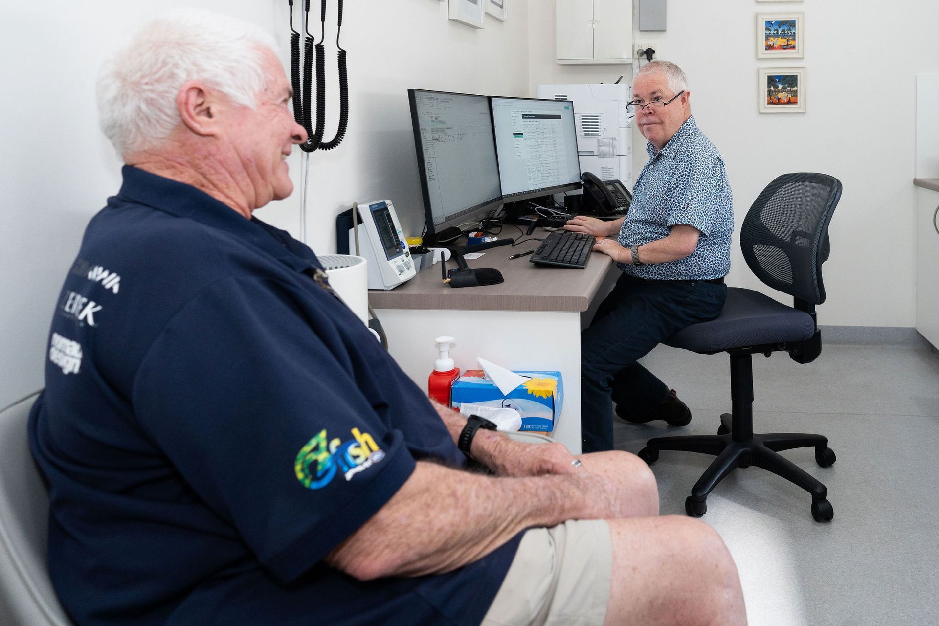 Doctor and patient in office, doctor at computer, patient seated — Tewantin Medical Centre In Tewantin, QLD