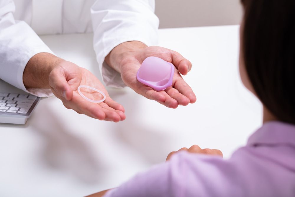 Doctor Holding Vaginal Ring and Diaphragm, Explaining Options to Patient — Tewantin Medical Centre In Tewantin, QLD