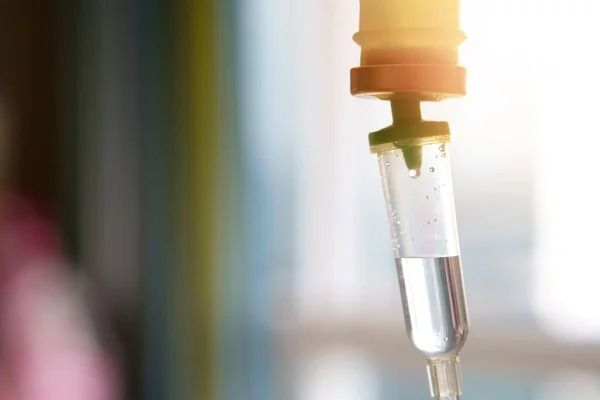 IV Drip Bag With Clear Liquid, Dispensing Fluid Into a Clear Tube — Tewantin Medical Centre In Tewantin, QLD