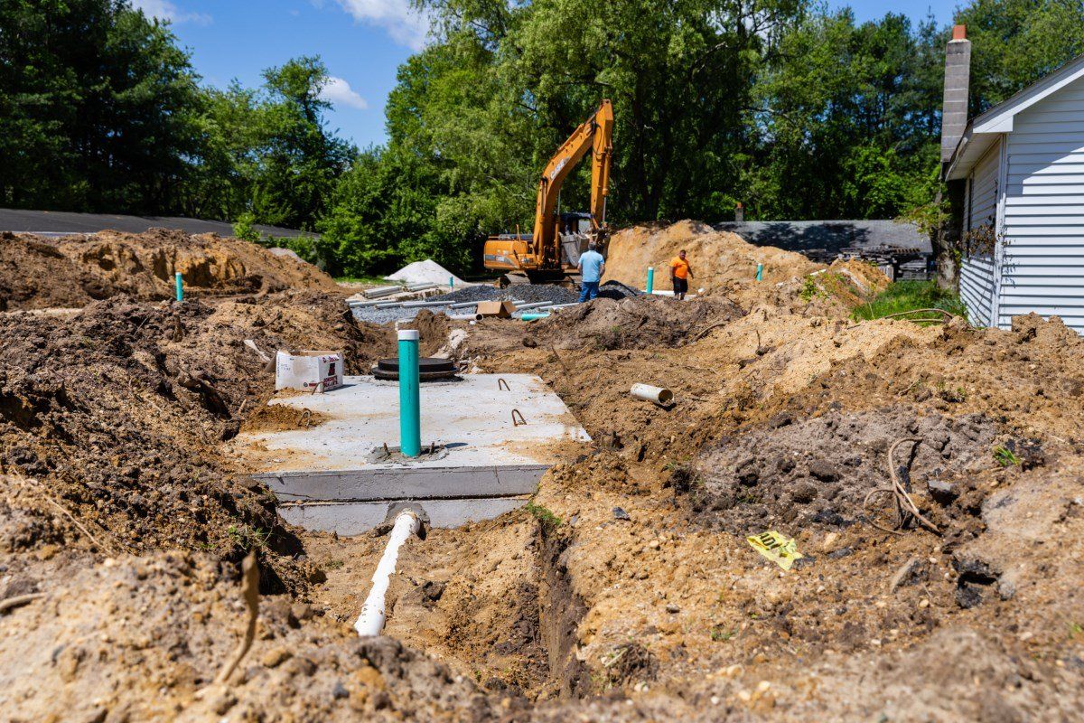 A construction site with a large excavator in the background.
