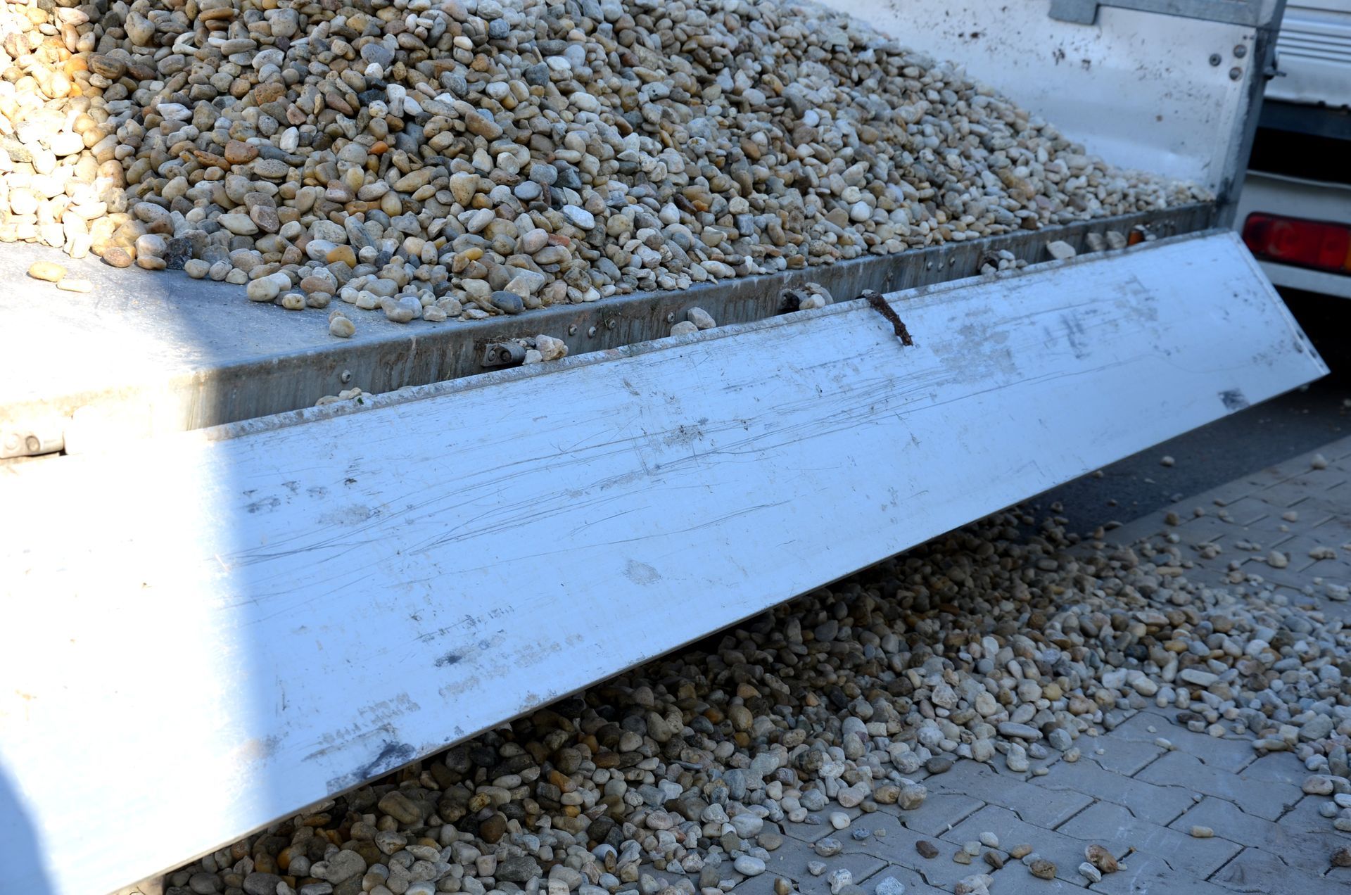 A pile of gravel is sitting on the back of a truck.