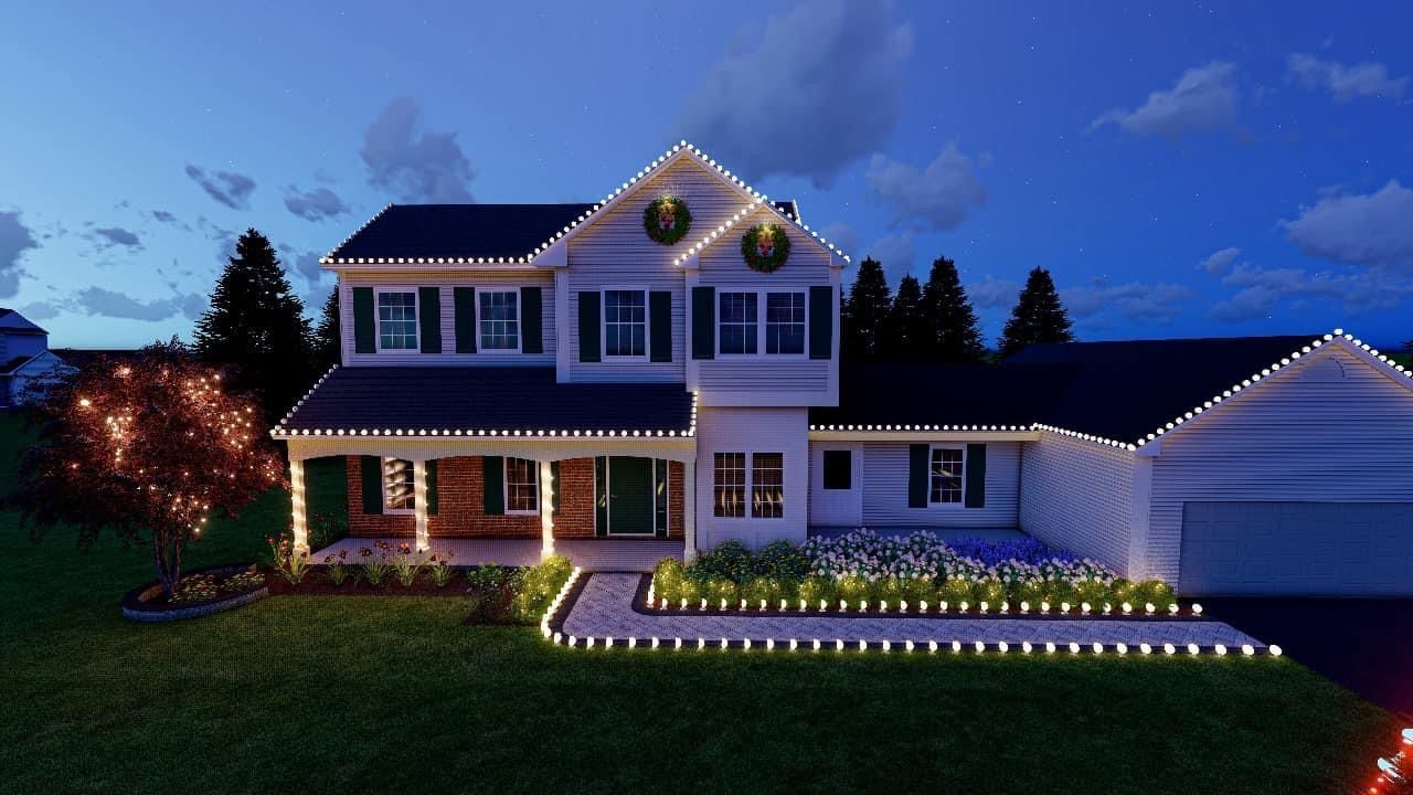 A two-story house at dusk outlined in warm white holiday lights, with a decorated tree and illuminated walkway.