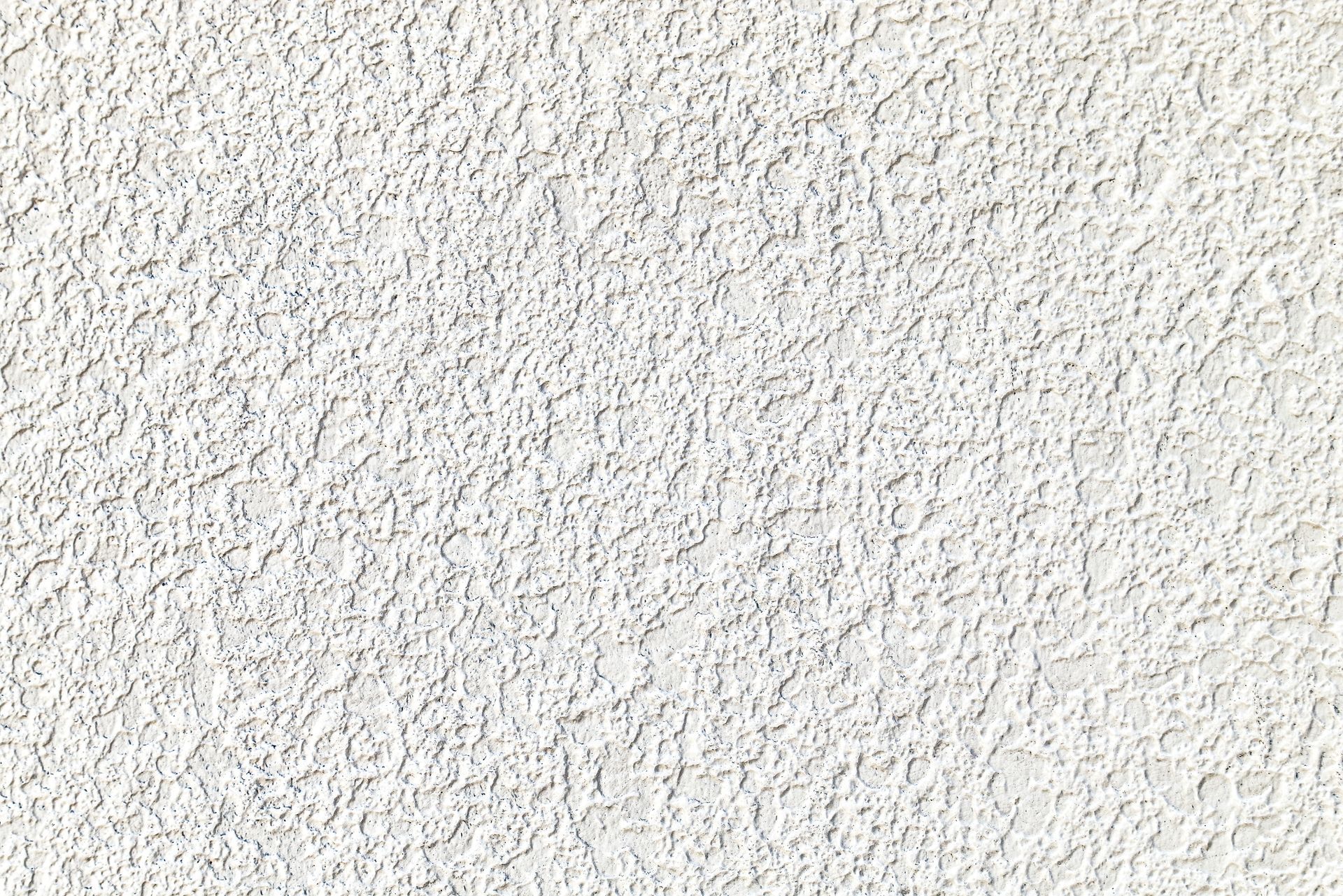 A white ceiling with a uniform, fine-textured popcorn finish.