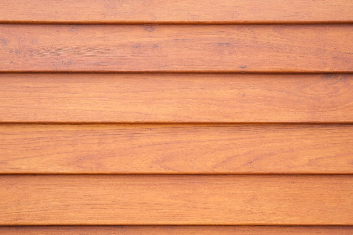 Horizontal light brown wooden planks with visible wood grain and consistent spacing between boards.