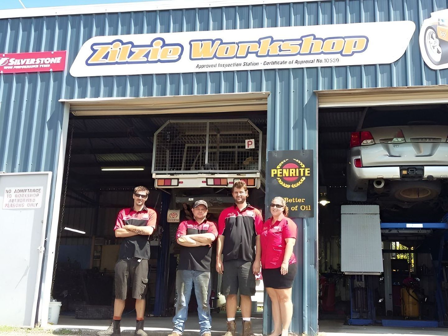 A Group of mechanics standing infront of a workshop — Zilzie Workshop In Emu Park, QLD