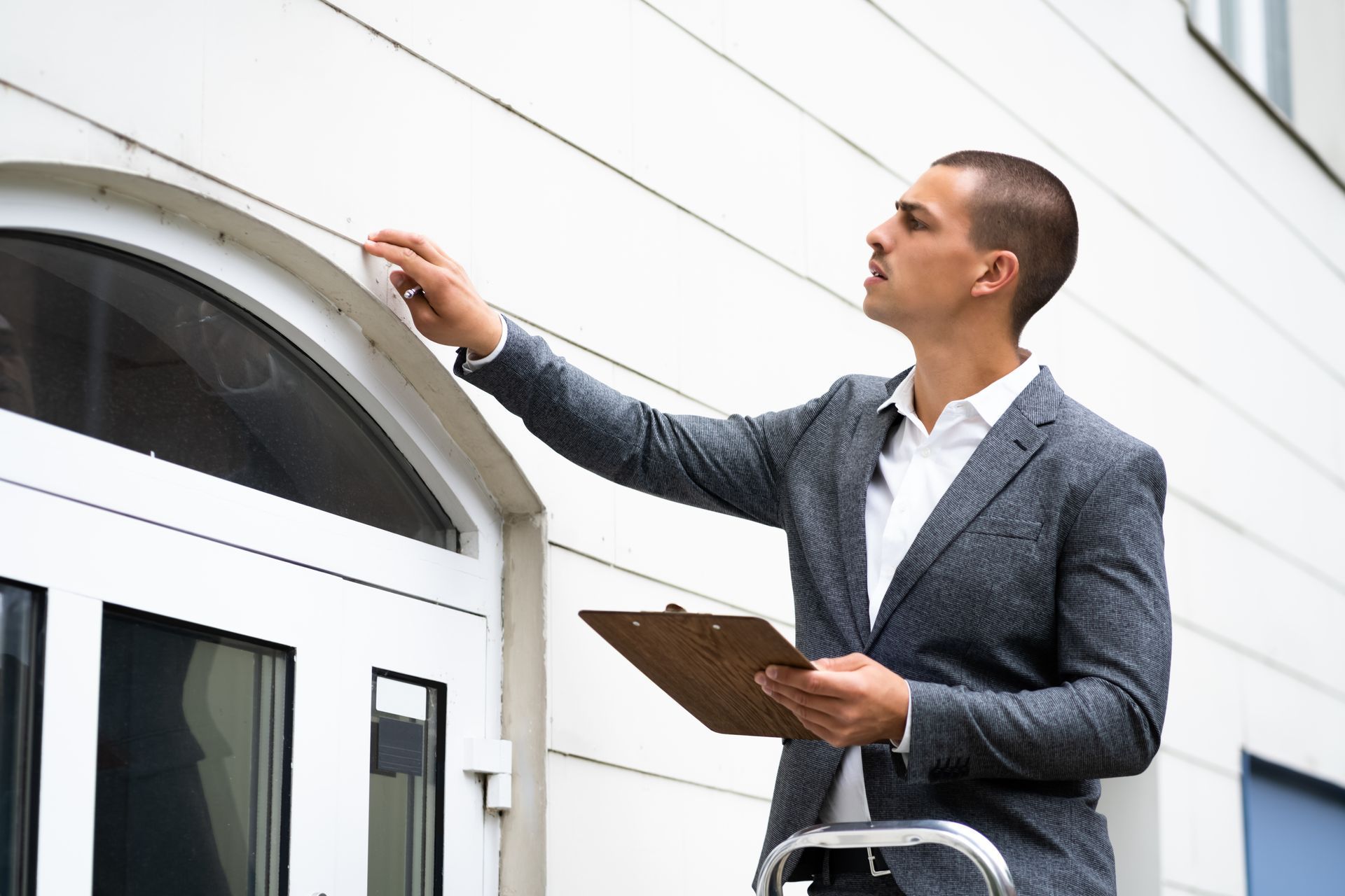 real estate property appraisal. man inspecting housereal estate property appraisal. man inspecting house