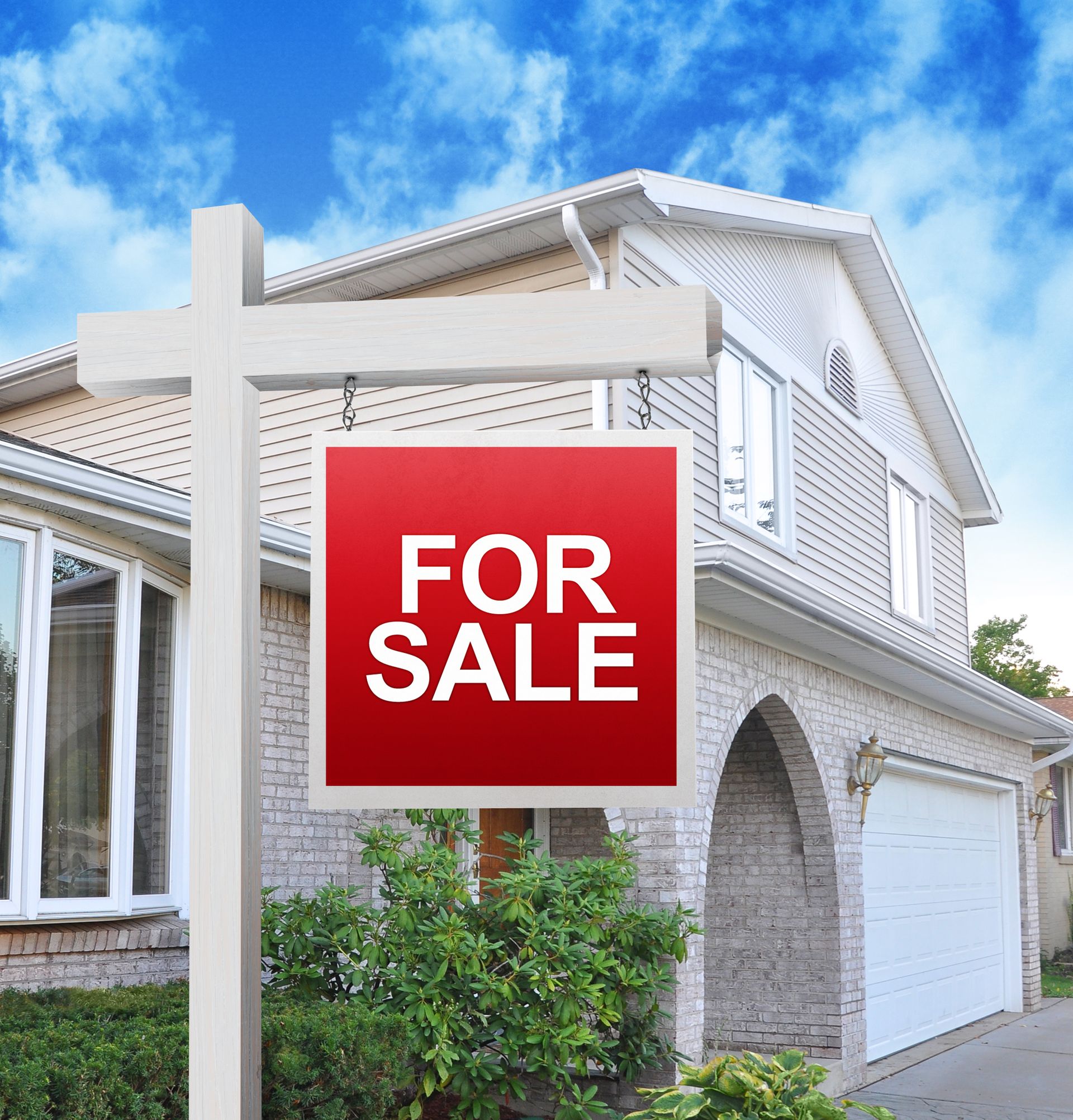 a home is advertising a for sale sign on a wooden sign post in red.