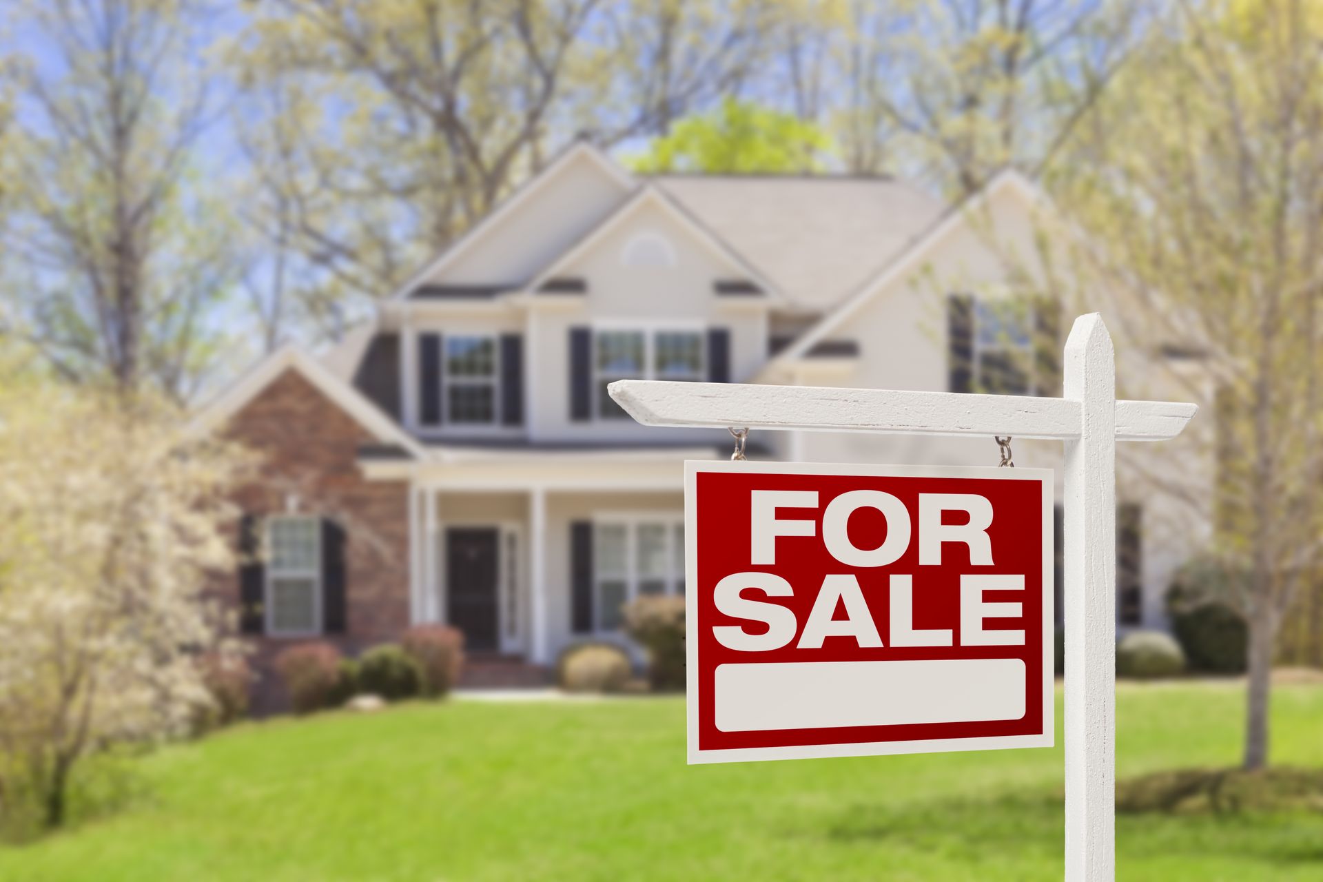 for sale sign in front of the house