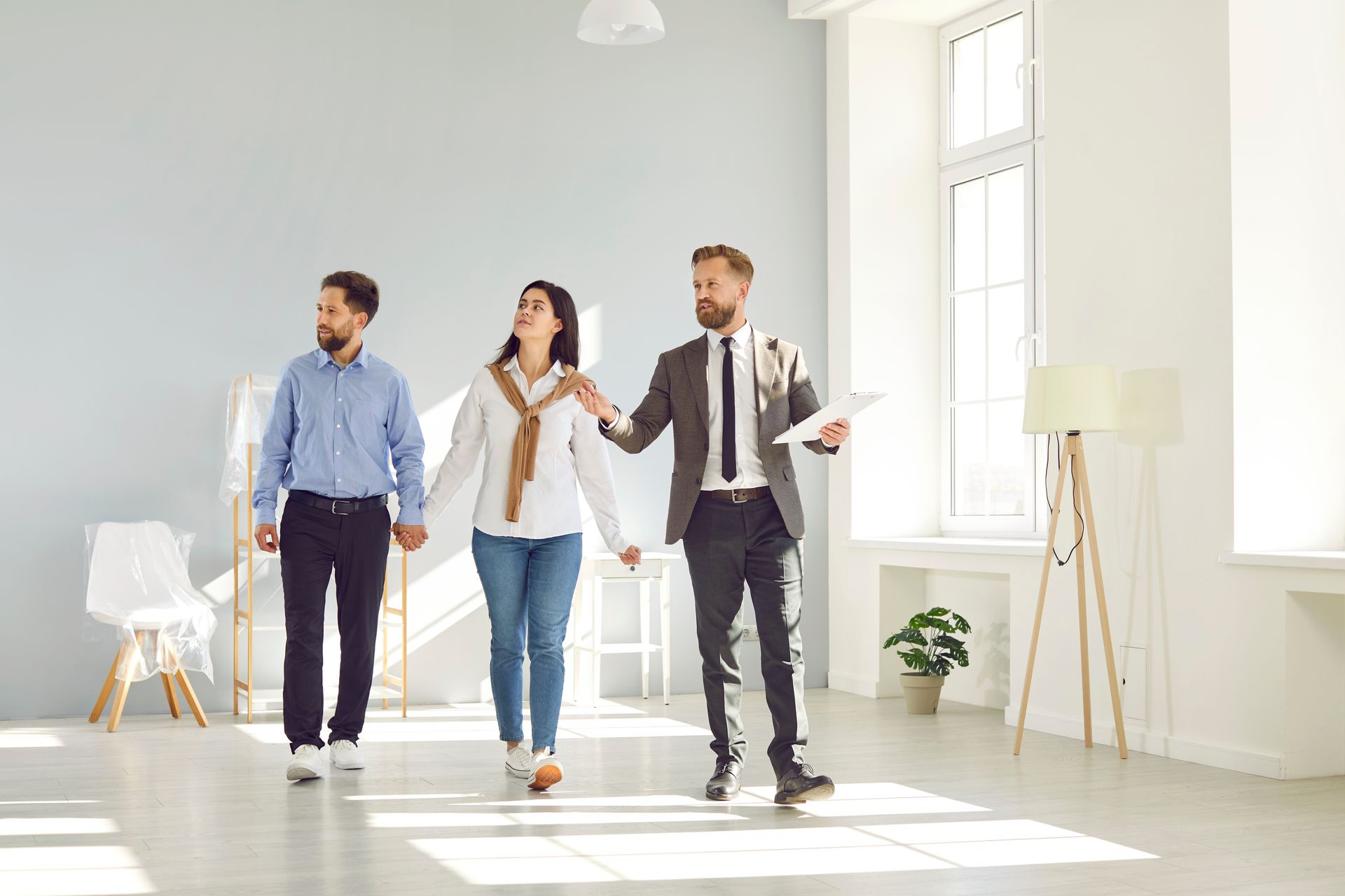 agent assisting copule for house tour