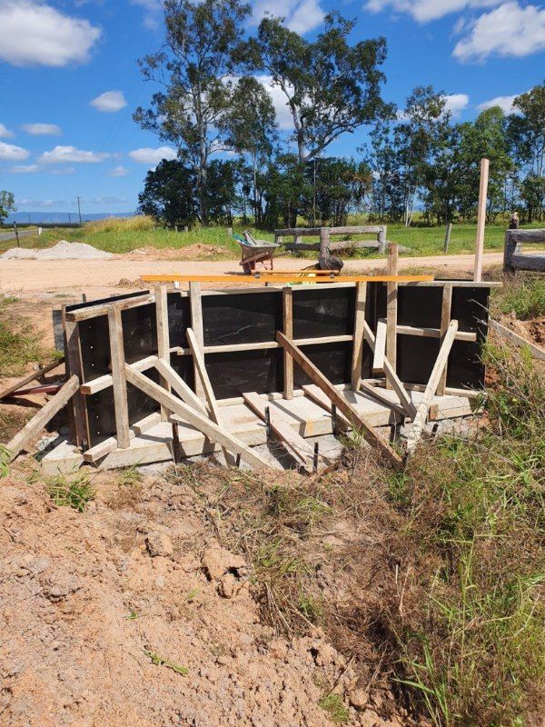 A Concrete Wall Is Being Built In A Field — Bark Concreting In Ryan, QLD