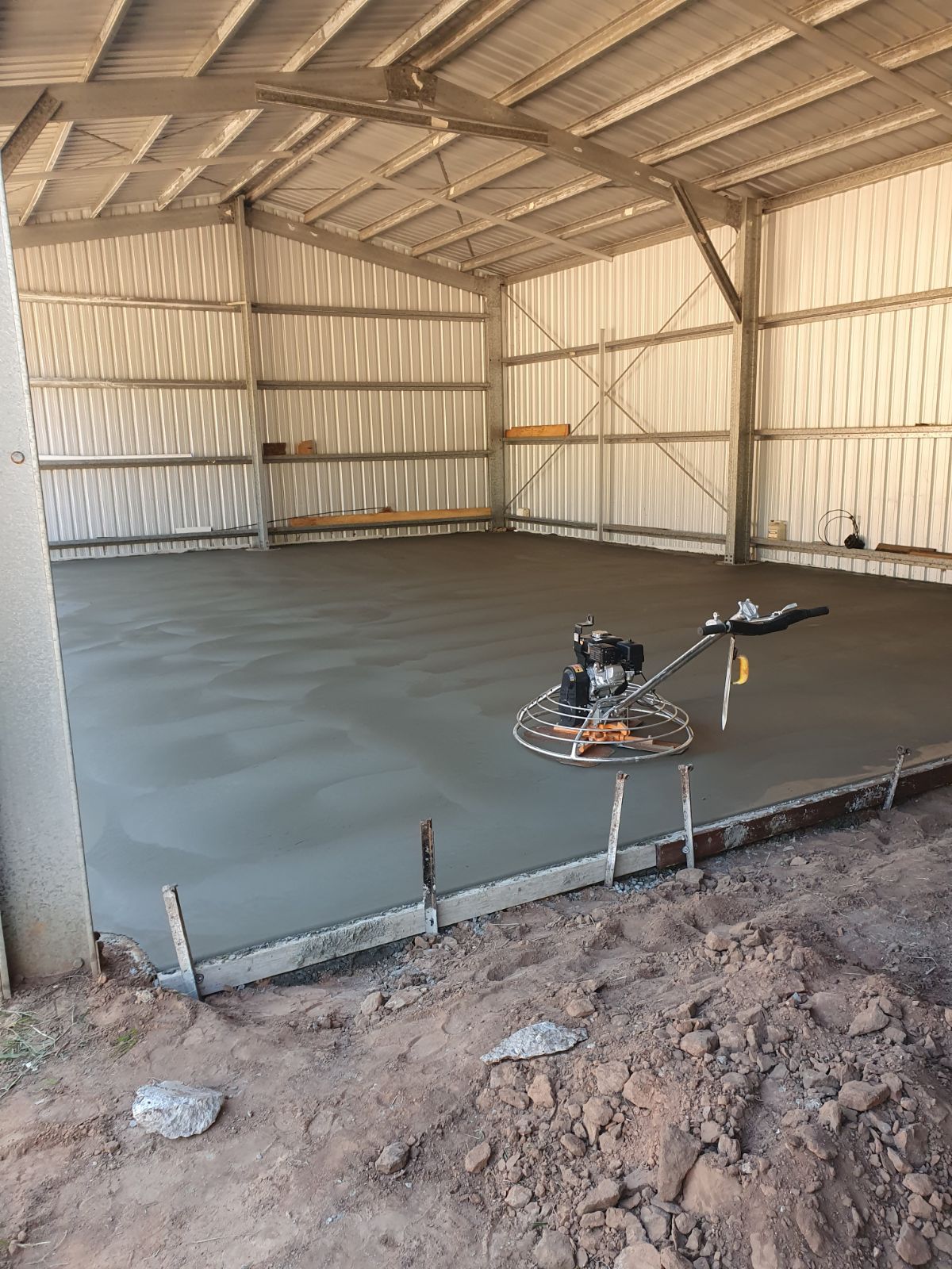 A Concrete Walkway With a Geometric Pattern Painted on It — Bark Concreting In Ryan, QLD