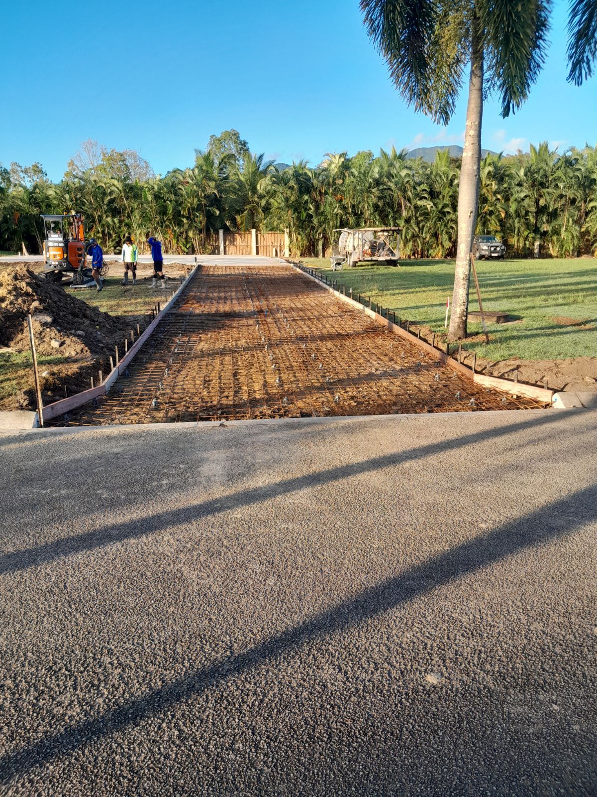 A Concrete Driveway is Being Built in Front of a House — Bark Concreting In Ryan, QLD