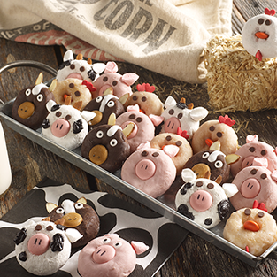 variety of mini donuts in a metal serving dish decorated as barnyard animals