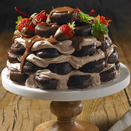 fudge round mini donuts layered with chocolate frosting and topped with fresh strawberries