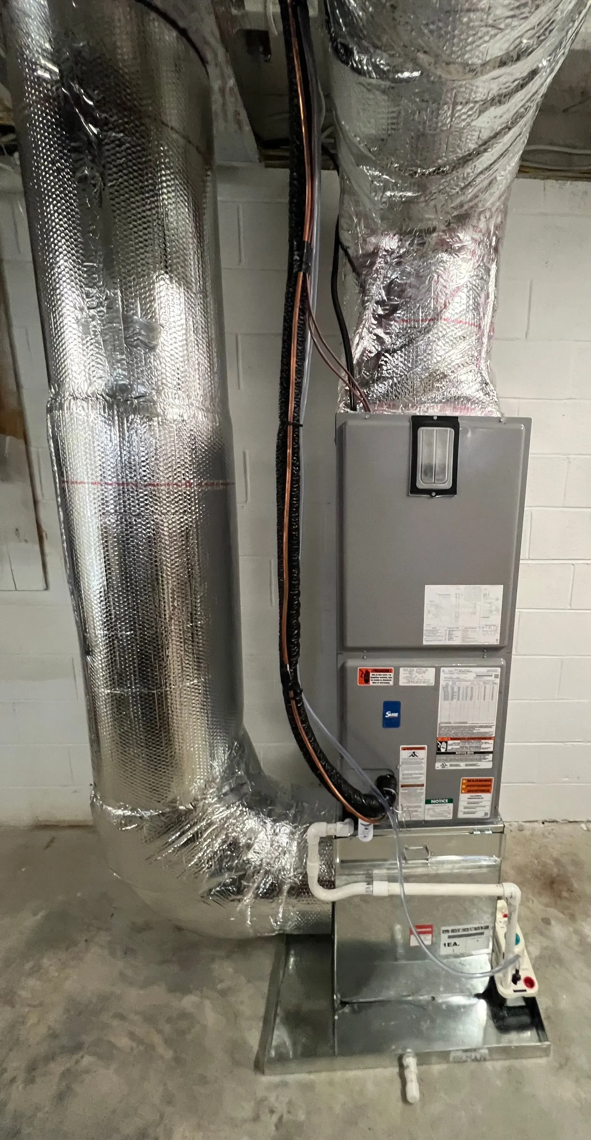 A picture of an air conditioner in a basement.