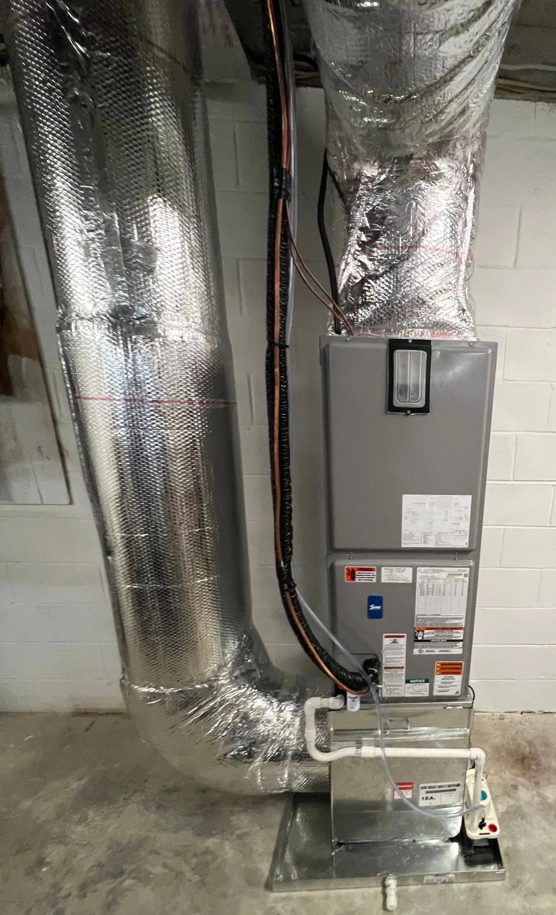 A picture of an air conditioner in a basement.