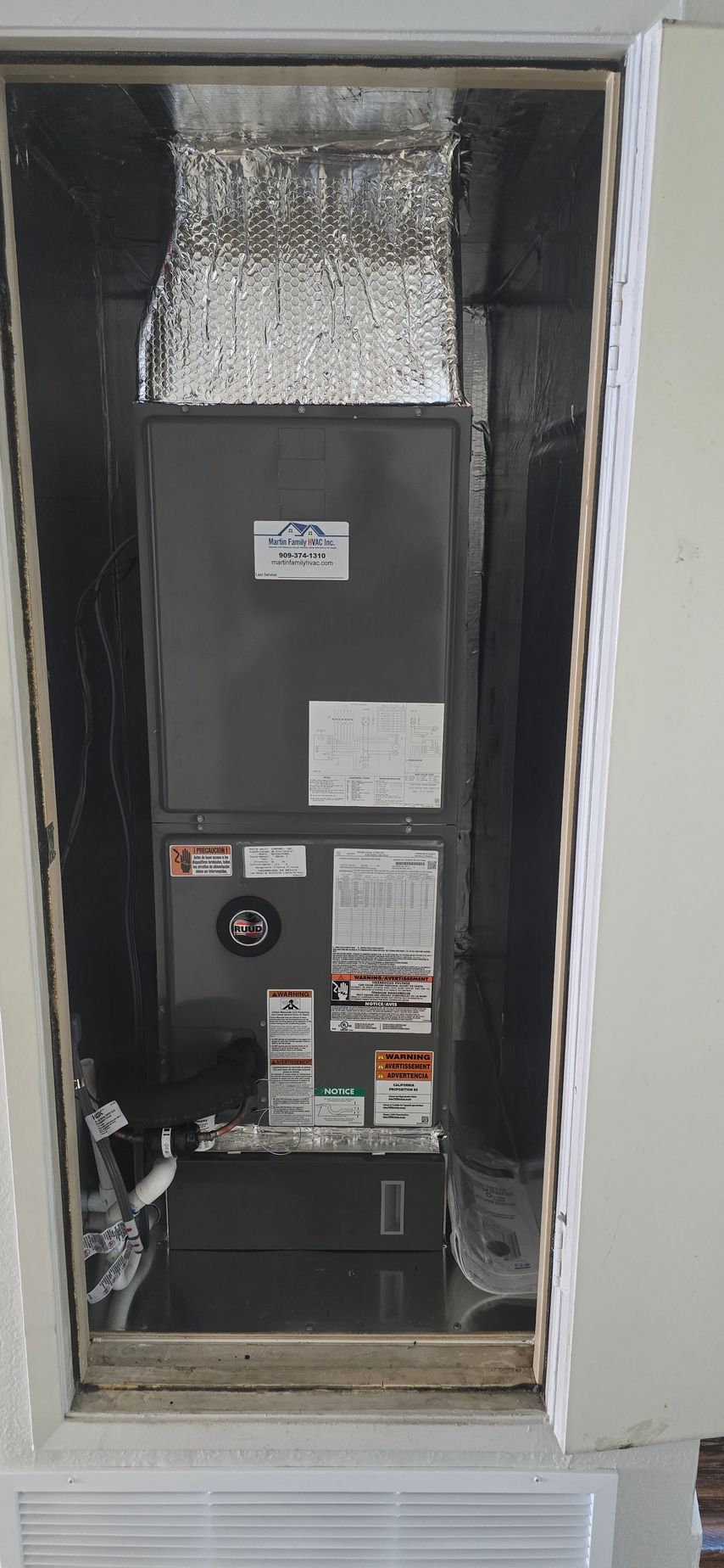 Outdoor HVAC service scene with a gray condenser unit, gauges, and tools on the ground