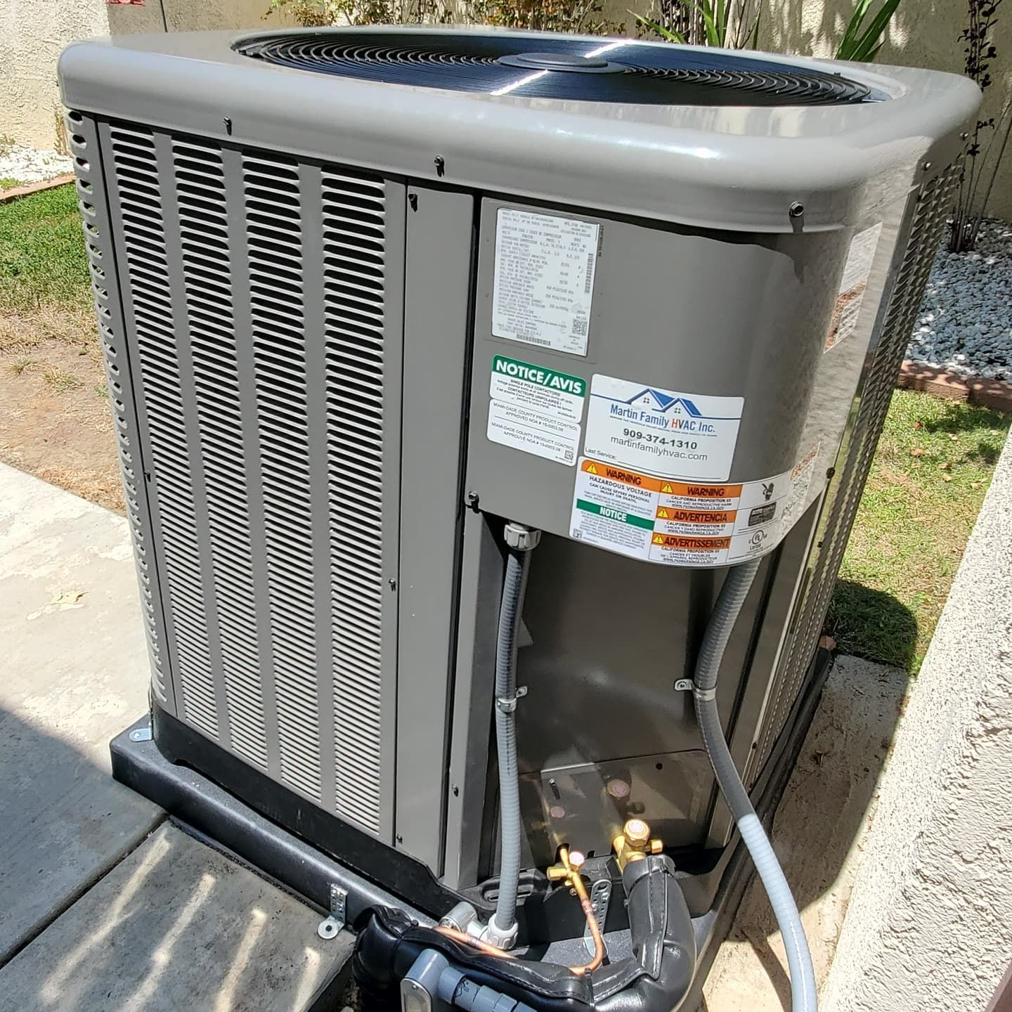 Open server cabinet with exposed wiring, circuit boards, and metal components outdoors.