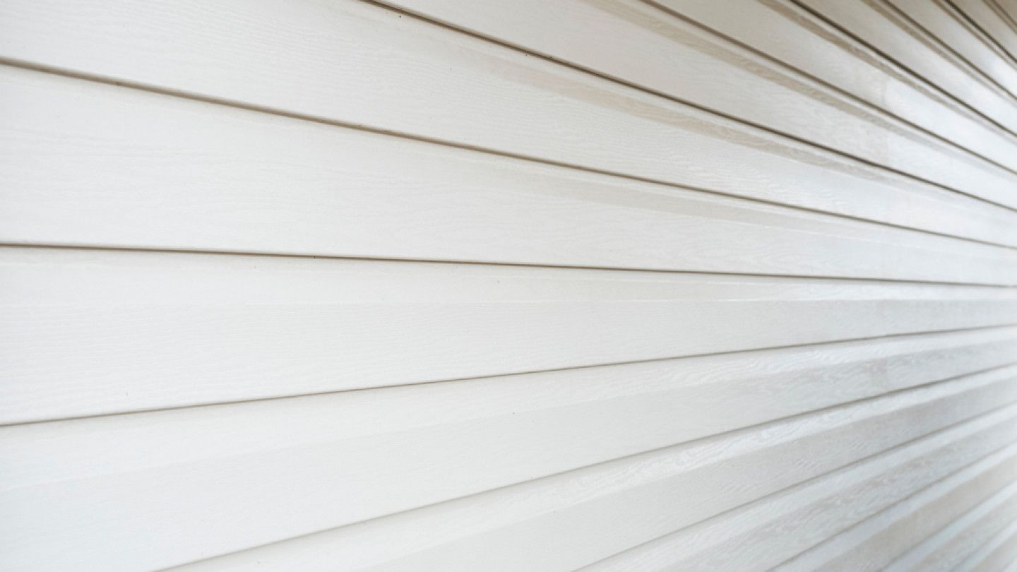 A close up of a white siding on a house
