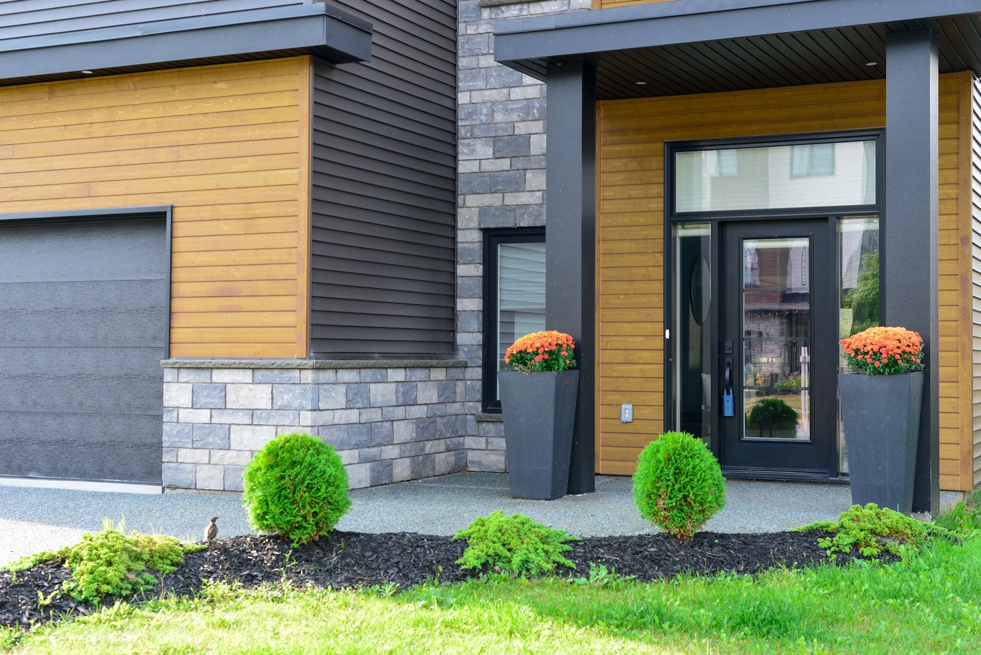 The front of a house with a garage and a porch 