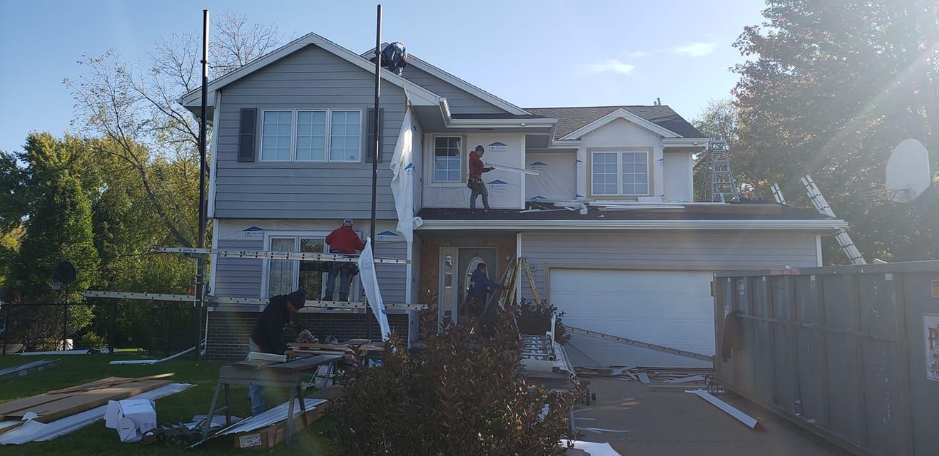 A man is standing on the roof of a house