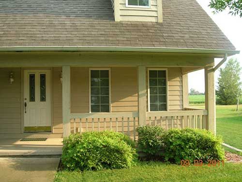 A house with a porch and a lot of windows
