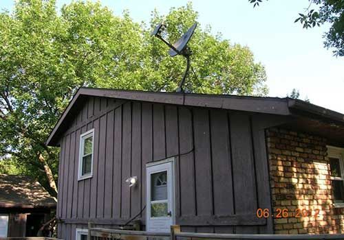 A small house with a satellite dish on the roof