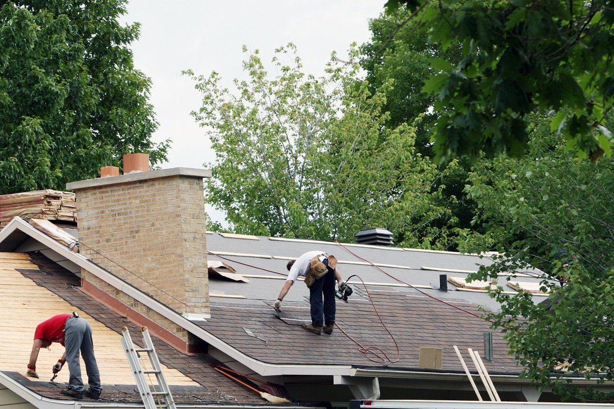 Roofers replacing shingles.
