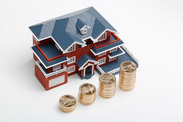 House model next to a notebook and calculator