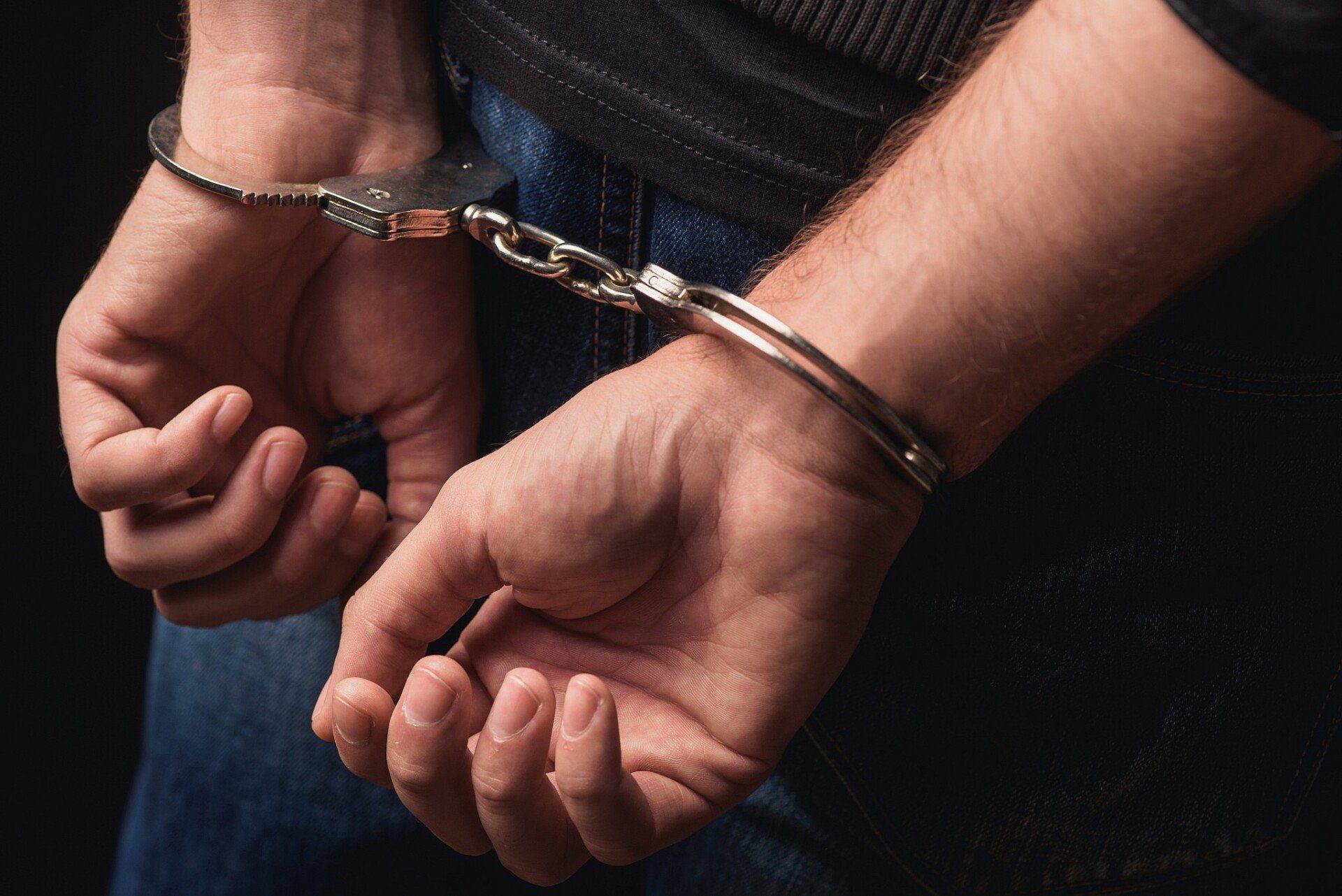 hands-handcuffed-behind-back