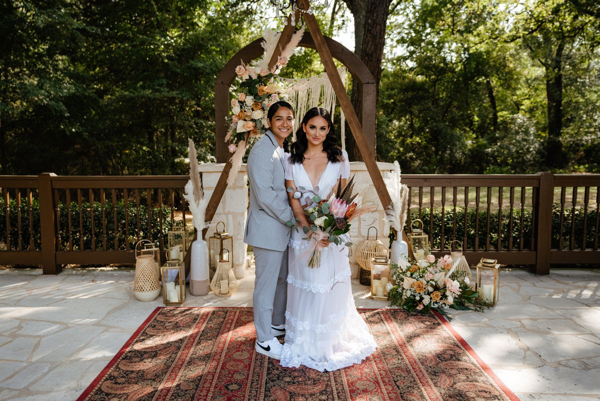 A bride and groom are posing for a picture at their wedding ceremony.