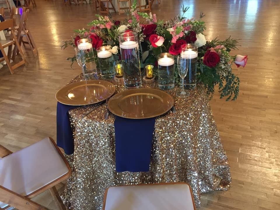 A table with plates , candles , and flowers on it.