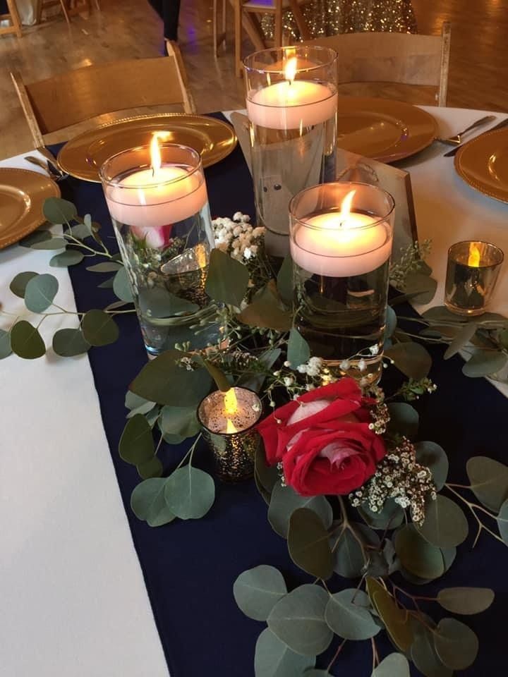 A table with candles and flowers on it