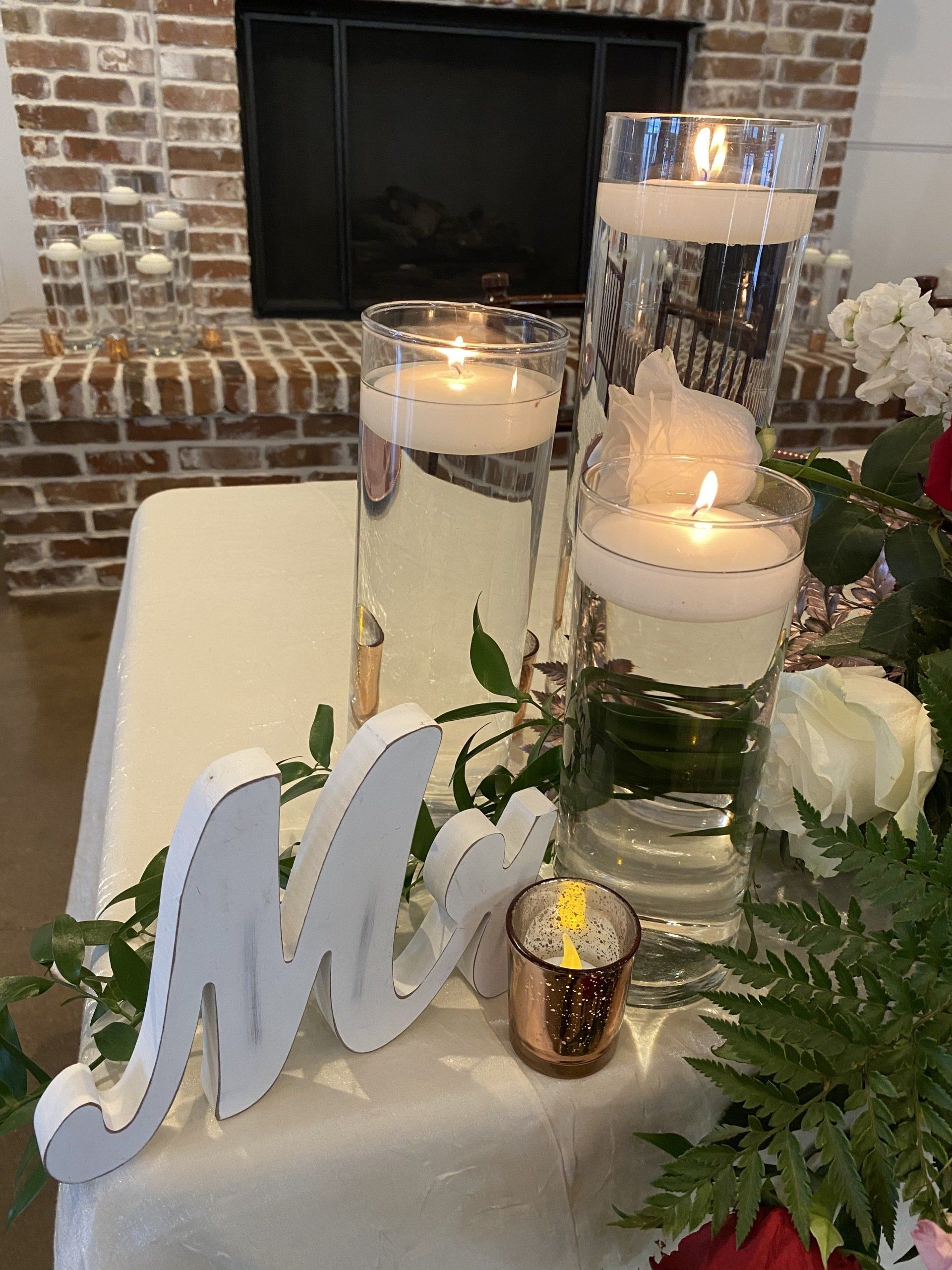 A table with candles and a sign that says mr. and mrs.