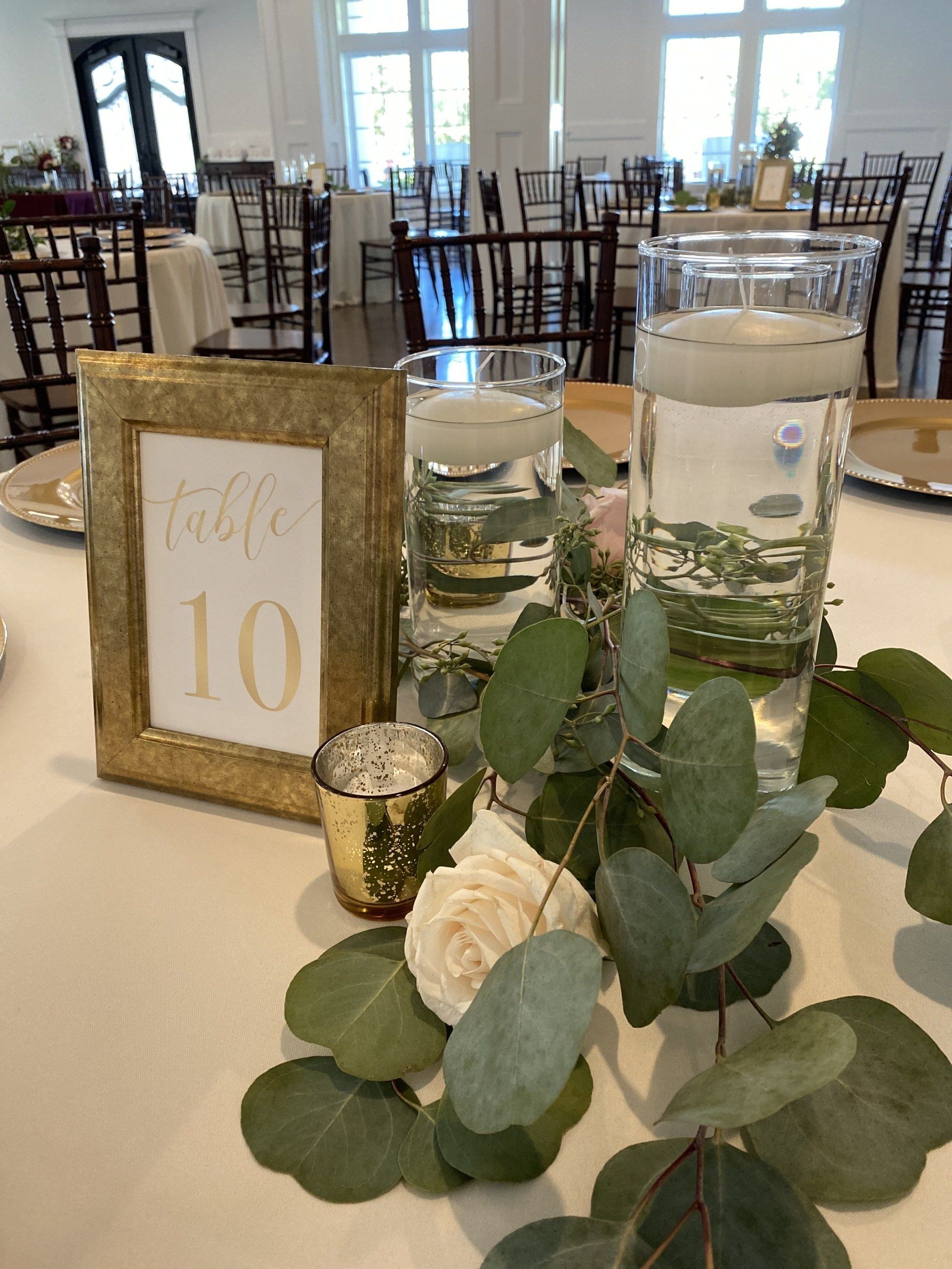 A table with a table number and flowers on it.