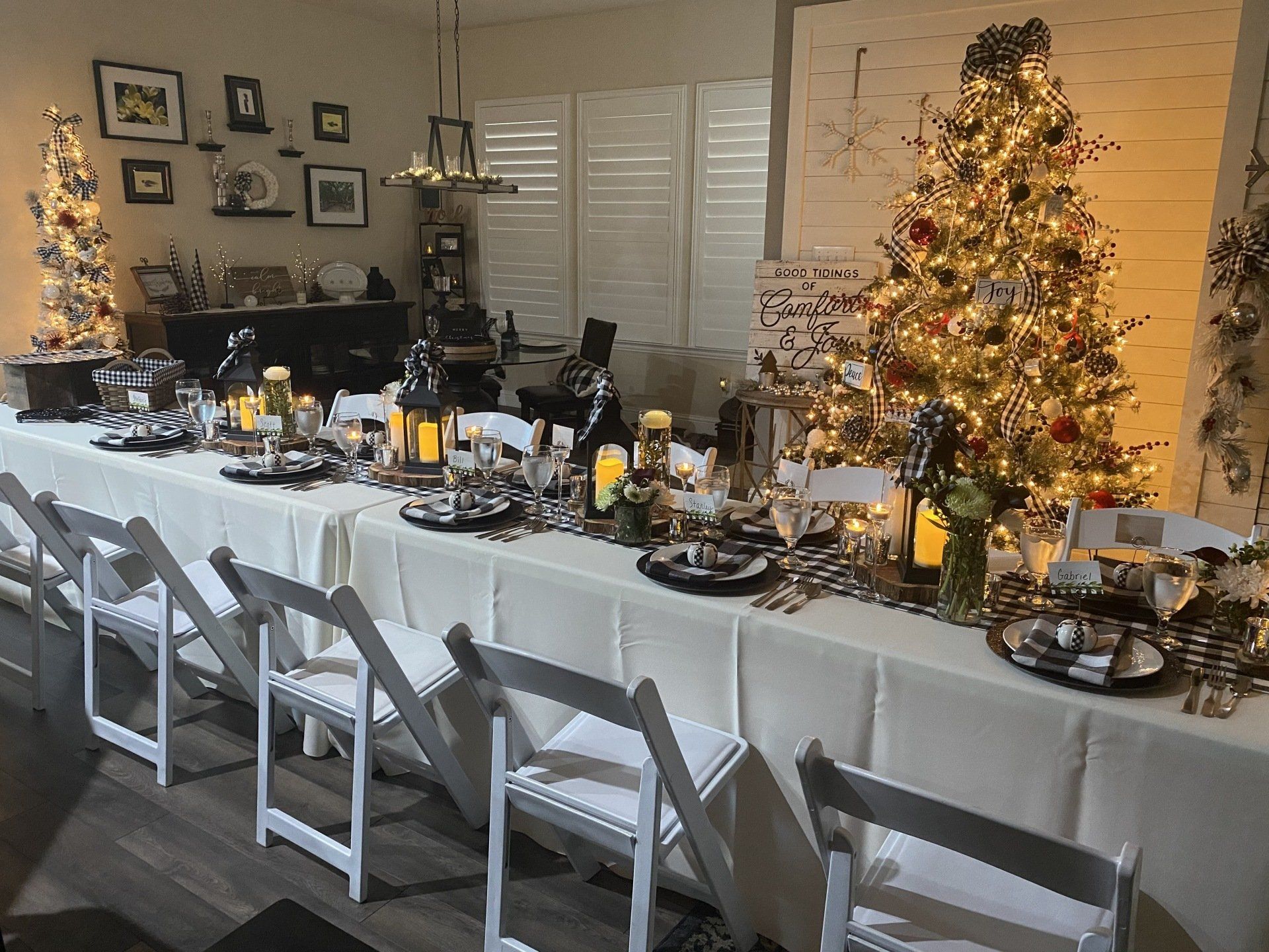 There is a long table with a christmas tree in the background.